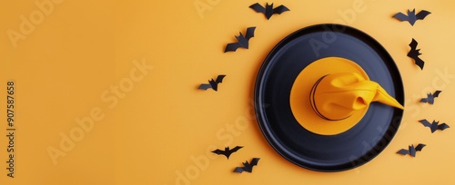 Creative Halloween Decor Featuring Black Bats and a Yellow Witch Hat on Orang...