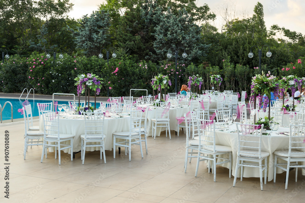 Beautifully Decorated Wedding Tables with Purple Flowers at Garden Event