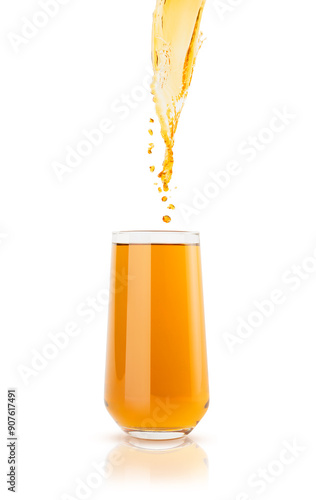 Flow of apple yellow cold juice pouring in calm glass with bright drops flying, isolated on white background. Refreshing summer pear beverage, splashing for advertising, design, flyer, card, poster.