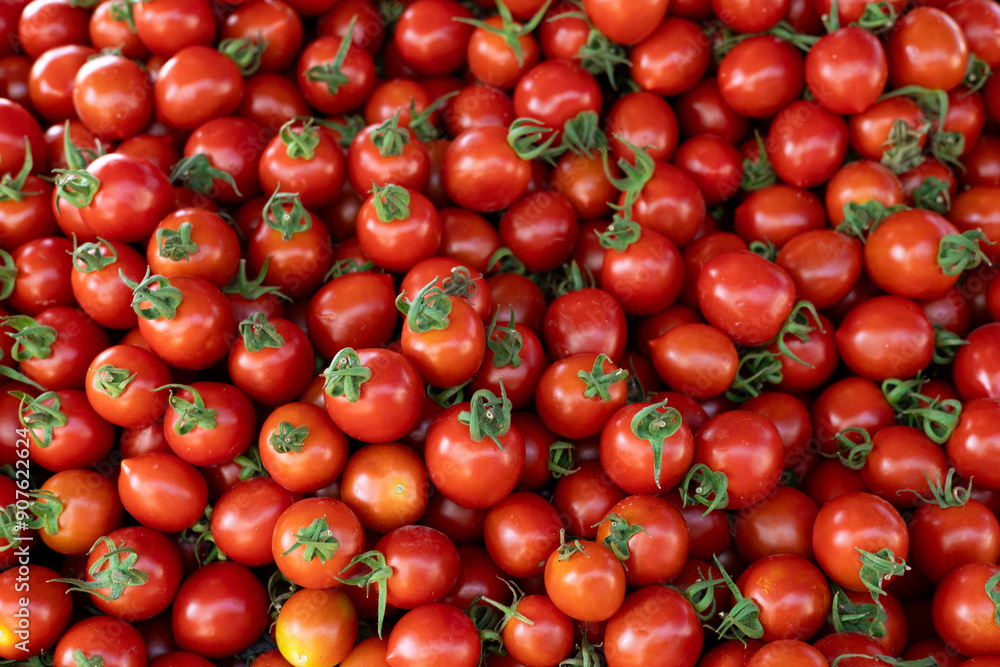 Many small red cherry tomatoes on a counter at a Turkish bazaar Many small red cherry tomatoes on a counter at a Turkish bazaar