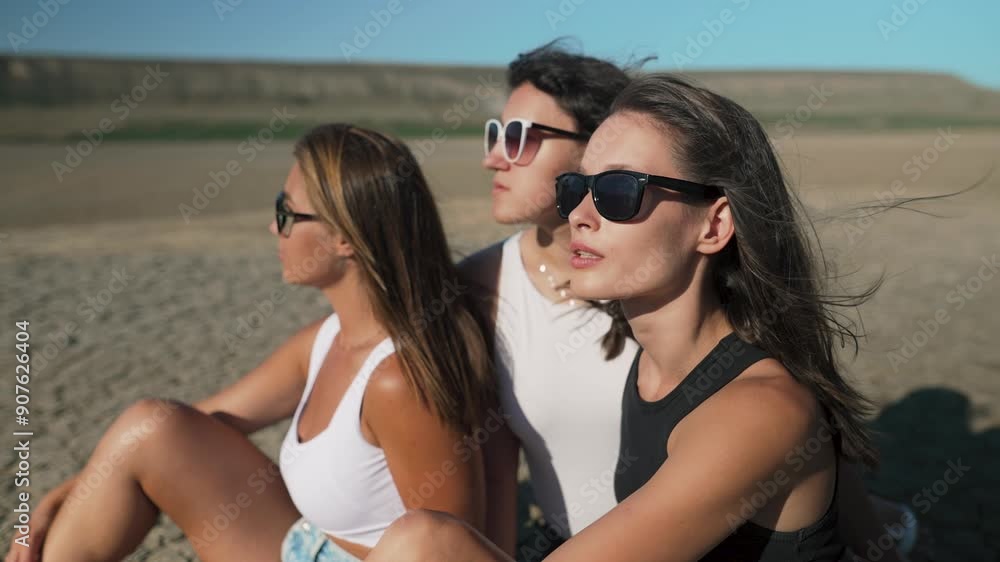 Three friends enjoying sunny day on desert Three friends enjoying sunny day on desert