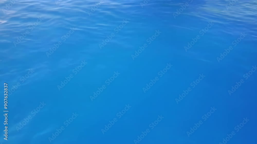 A tranquil blue water surface, showcasing serene motion and reflections, emphasizing relaxation and natural beauty A tranquil blue water surface, showcasing serene motion and reflections, emphasizing relaxation and natural beauty