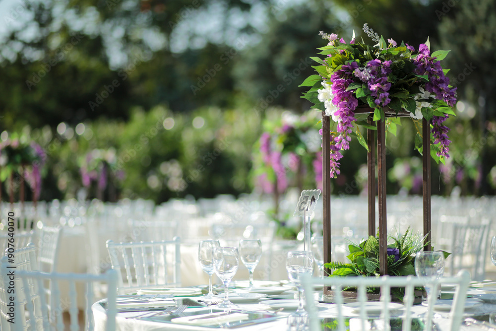 Elegant Outdoor Wedding Reception with Purple and White Floral Centerpieces