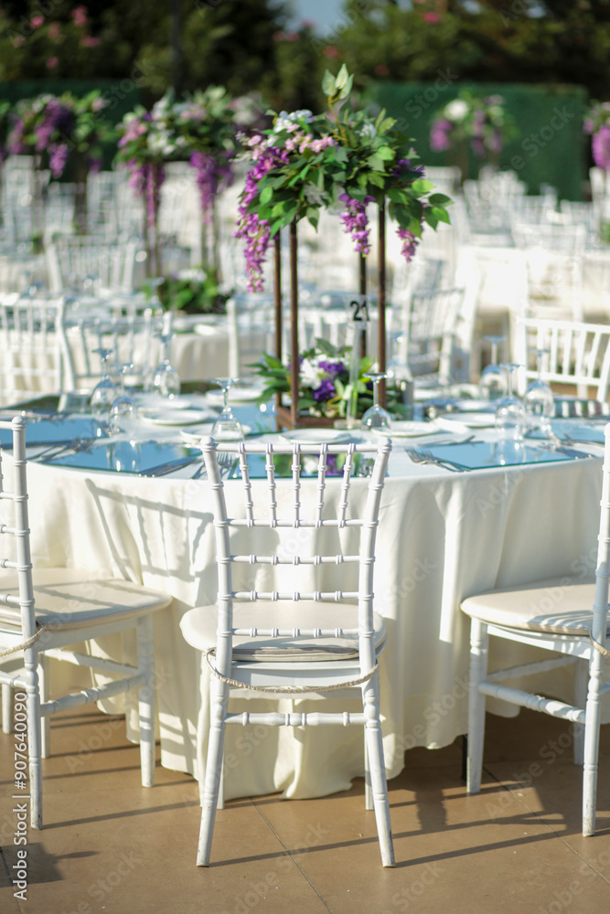 Elegant Outdoor Wedding Reception with Purple and White Floral Centerpieces