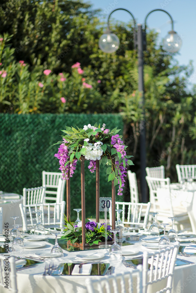 Elegant Outdoor Wedding Reception with Purple and White Floral Centerpieces