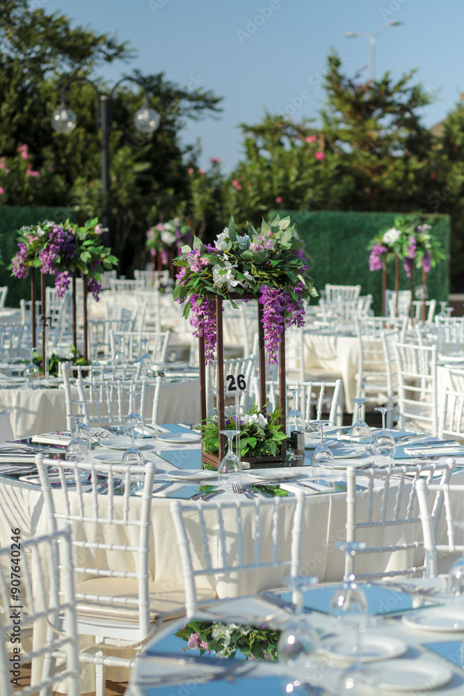 Elegant Outdoor Wedding Reception with Purple and White Floral Centerpieces