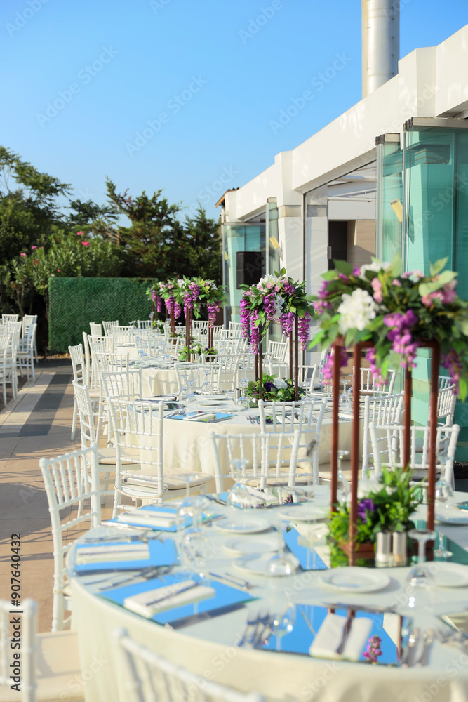 Elegant Outdoor Wedding Reception with Purple and White Floral Centerpieces
