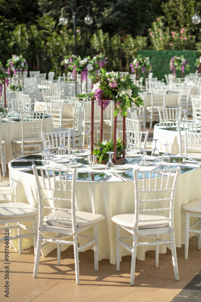 Elegant Outdoor Wedding Reception with Purple and White Floral Centerpieces