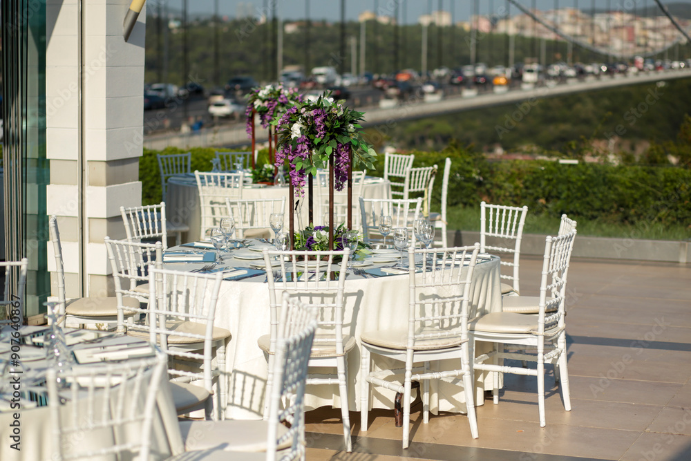 Elegant Outdoor Wedding Reception with Purple and White Floral Centerpieces