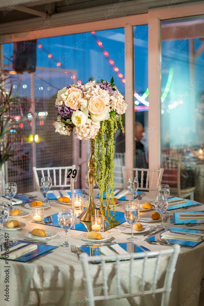 Charming Indoor Wedding Table Arrangement with White Decor and Night Cityscape