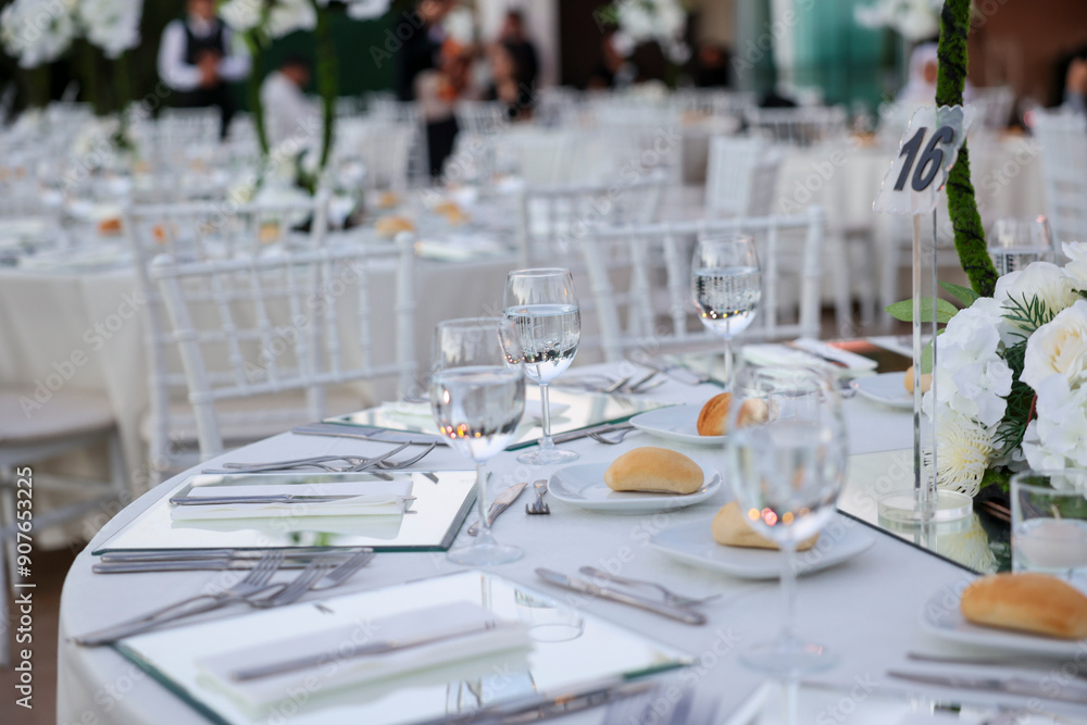 Elegant Indoor Wedding Reception with White Floral Centerpieces and Mirror Chargers