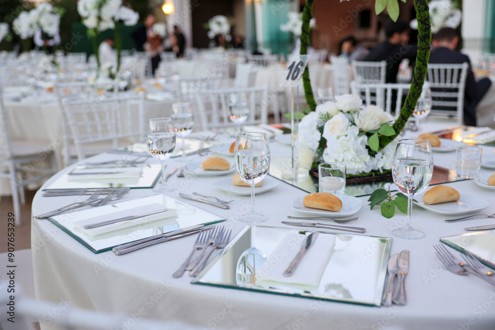 Elegant Indoor Wedding Reception with White Floral Centerpieces and Mirror Chargers