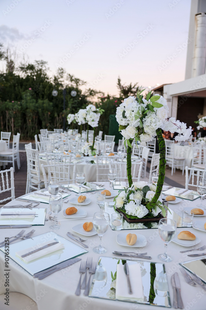Elegant Indoor Wedding Reception with White Floral Centerpieces and Mirror Chargers