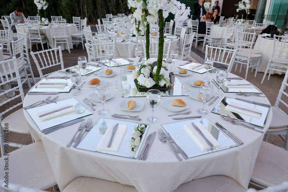 Elegant Indoor Wedding Reception with White Floral Centerpieces and Mirror Chargers