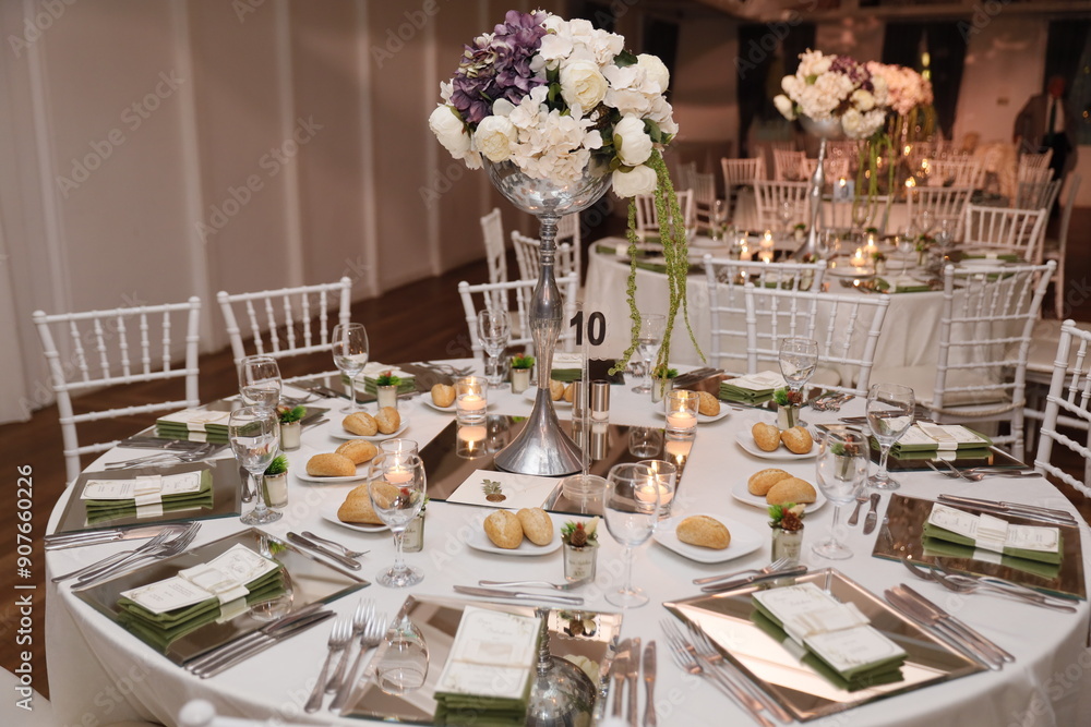 Elegant Wedding Venue with Floral Centerpieces and White Chairs