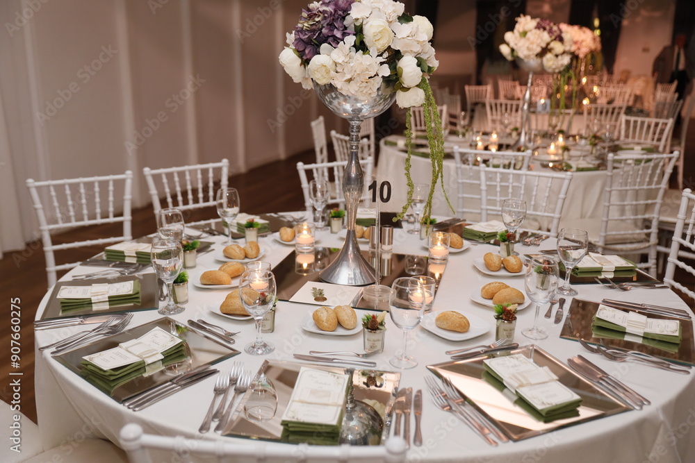 Elegant Wedding Venue with Floral Centerpieces and White Chairs