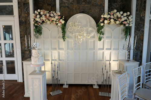 Obraz na płótnie Refined Wedding Cake Presentation with Flowers and Lighting Inside Venue w salonie