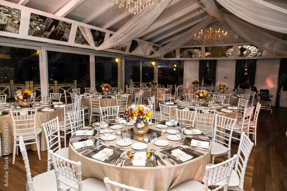 Romantic Dinner Setup: Table with Sunflower Bouquet and Cityscape at Night