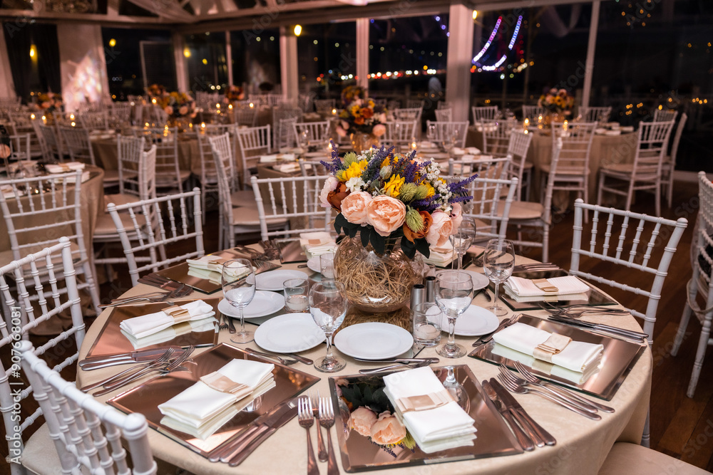 Romantic Dinner Setup: Table with Sunflower Bouquet and Cityscape at Night