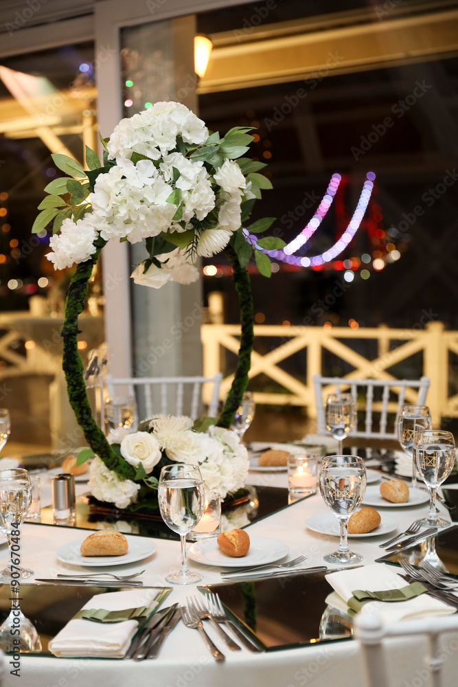 Romantic Dinner Setup: Table with Sunflower Bouquet and Cityscape at Night