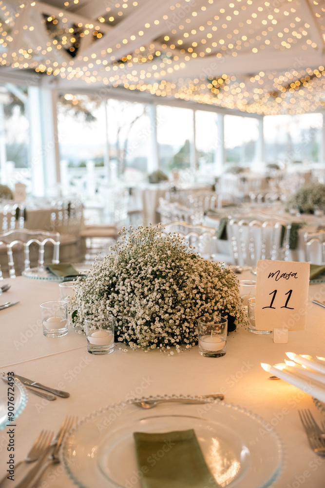 Romantic reception table with floral centerpiece and soft candlelight