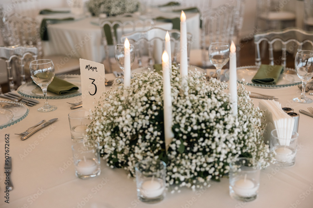 Romantic reception table with floral centerpiece and soft candlelight