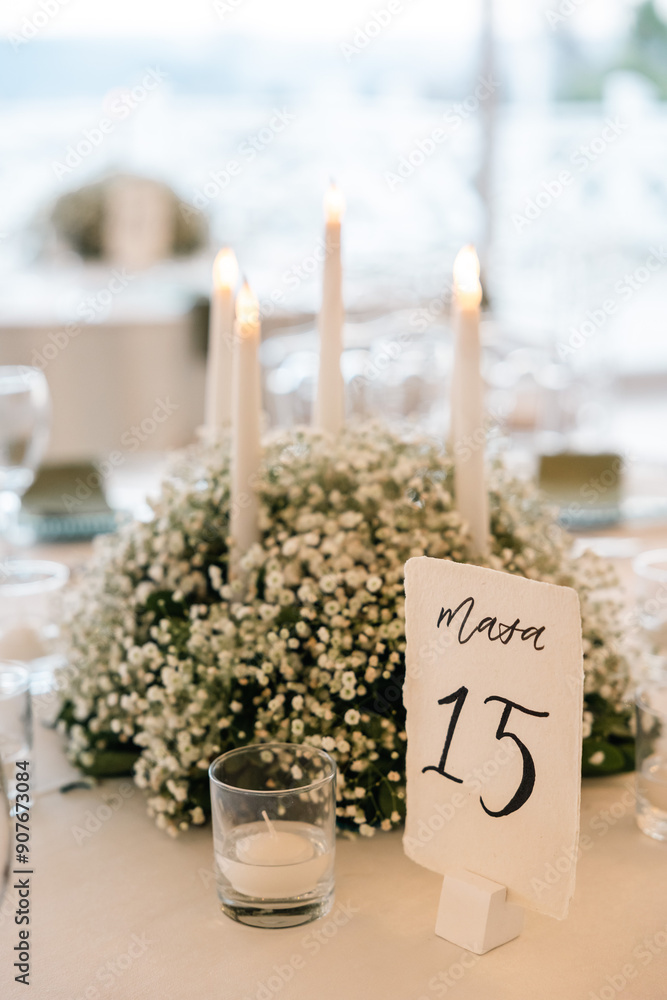 Romantic reception table with floral centerpiece and soft candlelight
