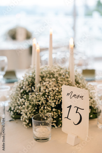 Romantic reception table with floral centerpiece and soft candlelight