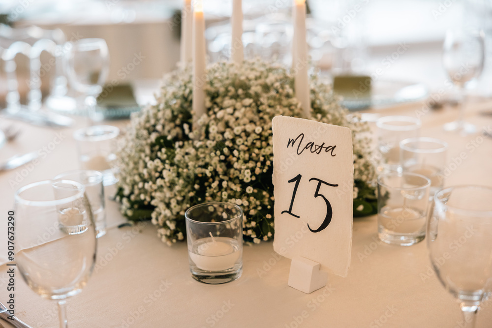 Romantic reception table with floral centerpiece and soft candlelight