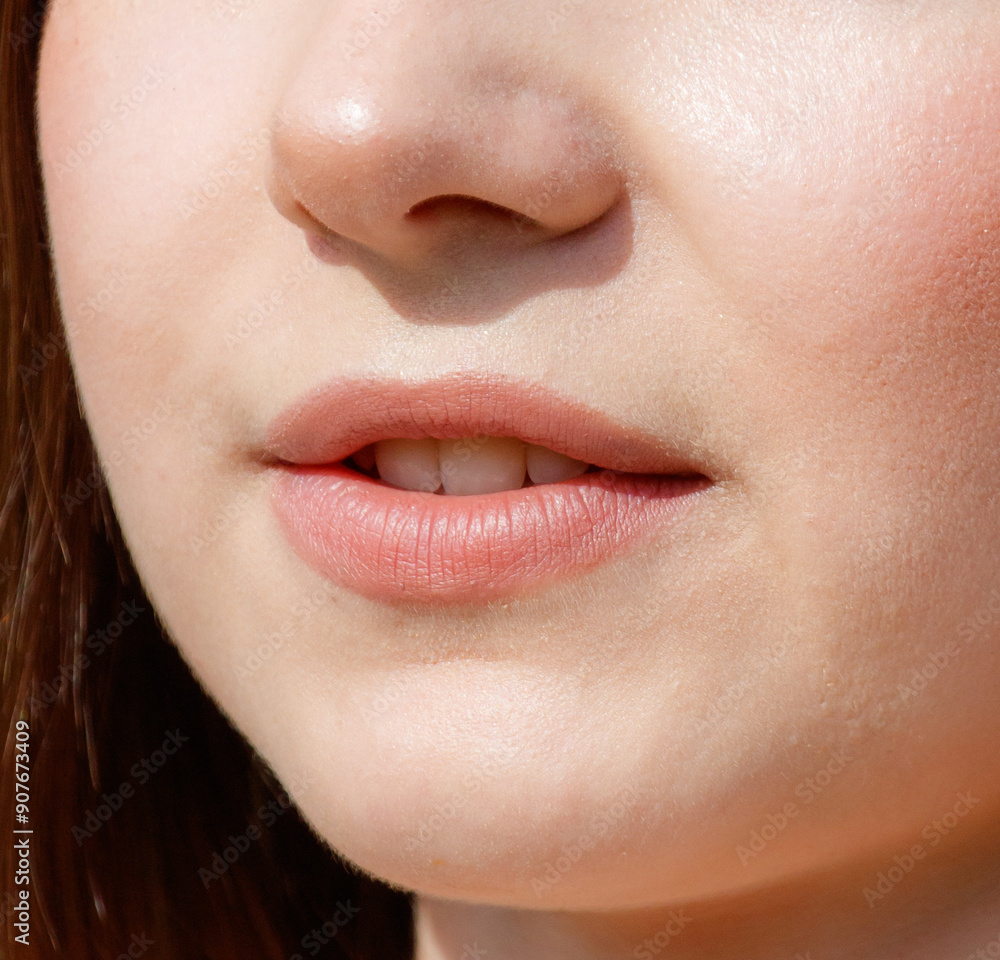 Obraz premium Close-up of lips on a girl's face. Macro