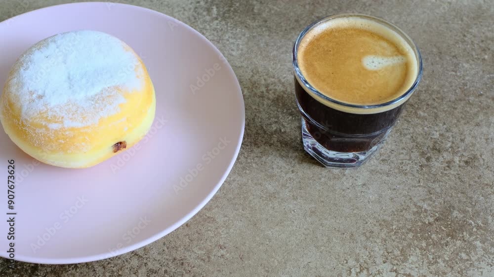 Close-up of berliner cake on a white plate and a cup of espresso Close-up of berliner cake on a white plate and a cup of espresso