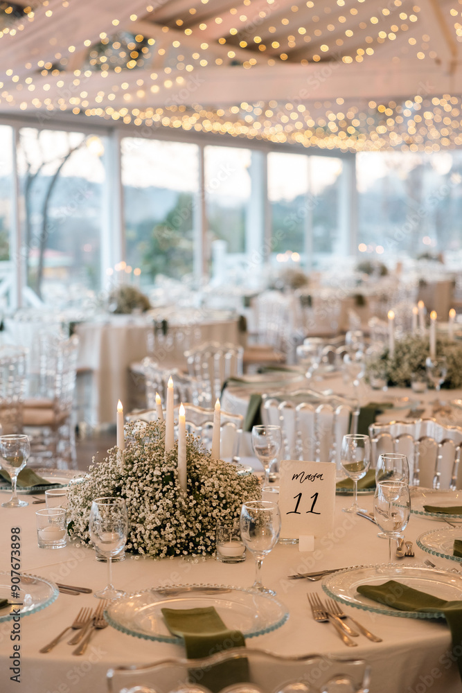 Romantic reception table with floral centerpiece and soft candlelight