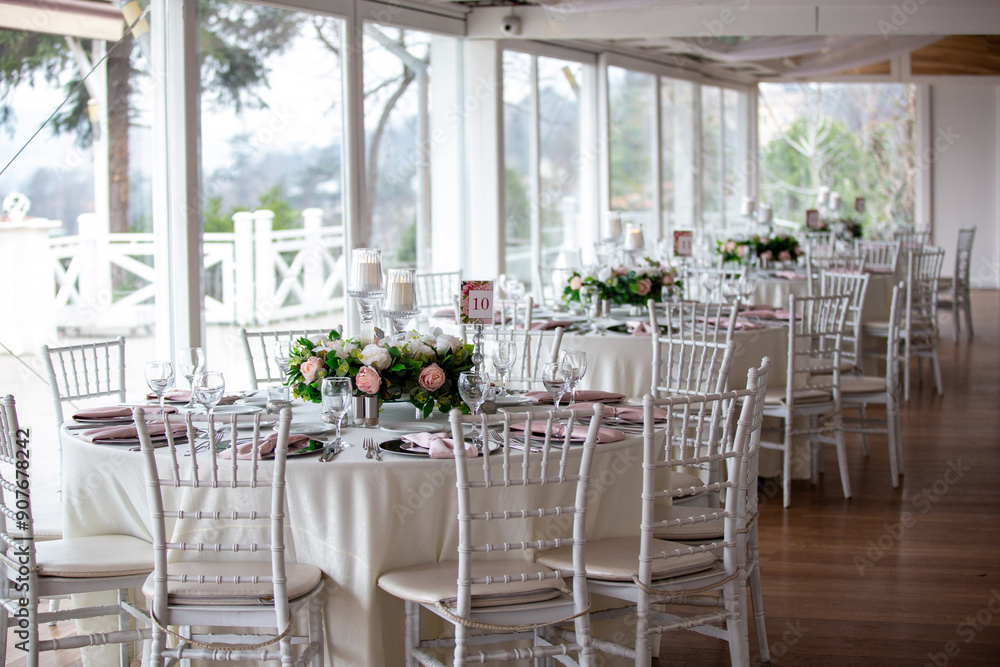 Elegant Indoor Wedding Reception with Pink and White Floral Centerpieces and Candles