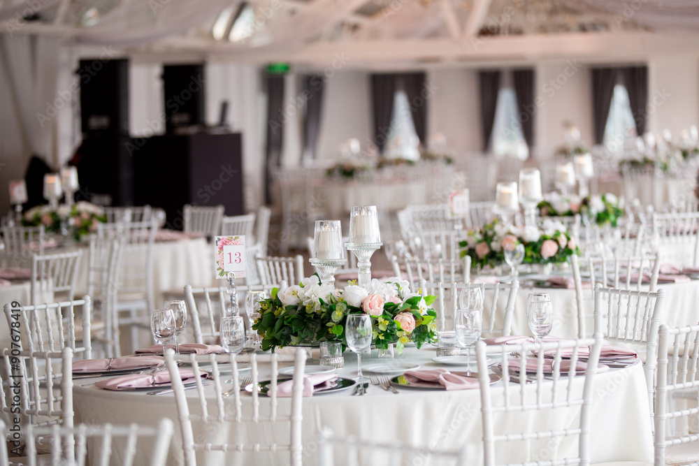 Elegant Indoor Wedding Reception with Pink and White Floral Centerpieces and Candles