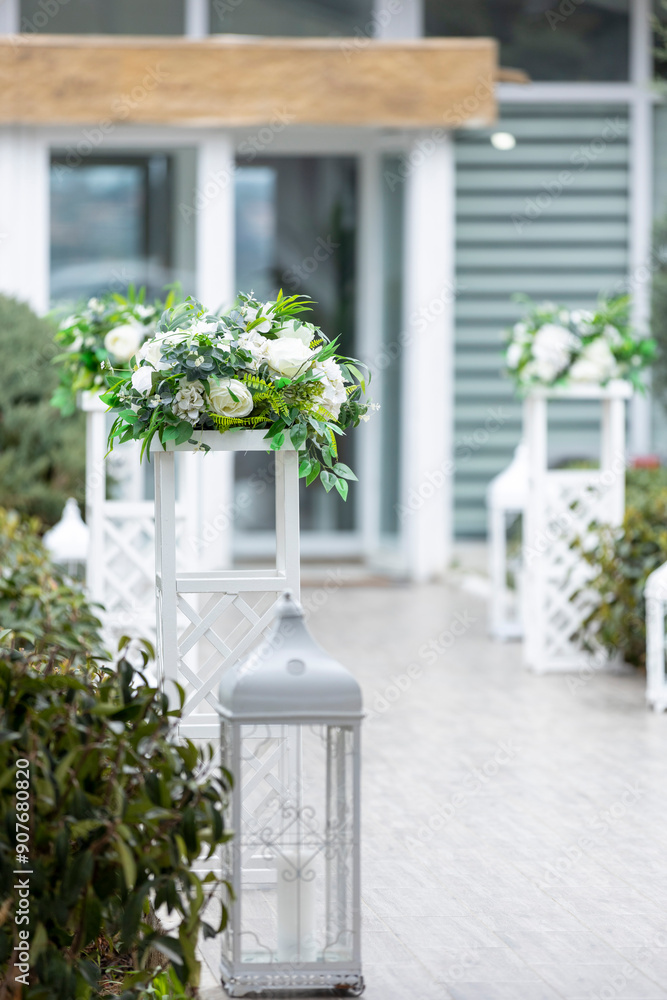 White Decorative Stands and Lanterns in Outdoor Venue for Romantic Wedding Ceremony