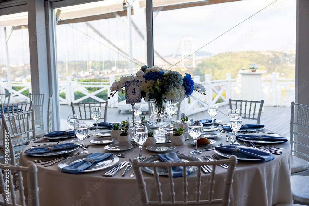 Beautiful Wedding Venue in Istanbul: Tables with Floral Centerpieces and Bridge View