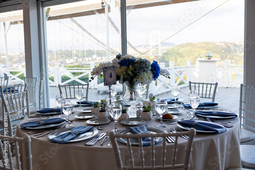 Obraz na płótnie Beautiful Wedding Venue in Istanbul: Tables with Floral Centerpieces and Bridge View w salonie