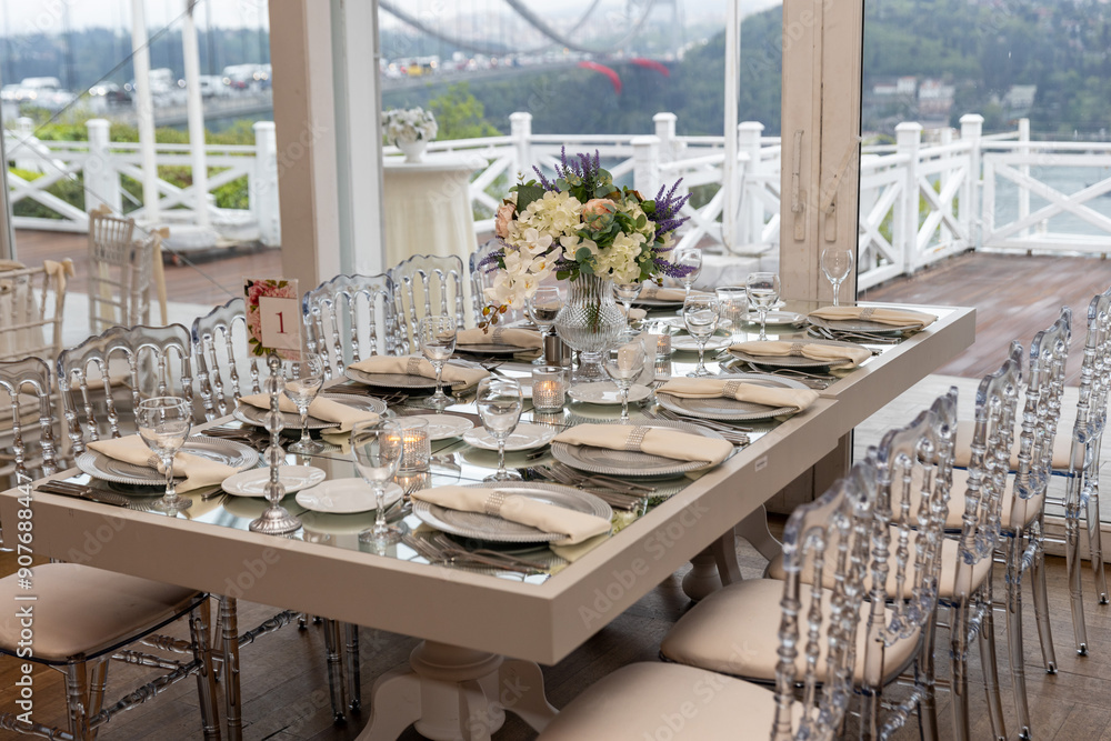 Stylish Outdoor Reception: Lounge Furniture with Floral Accents and Urban Panorama