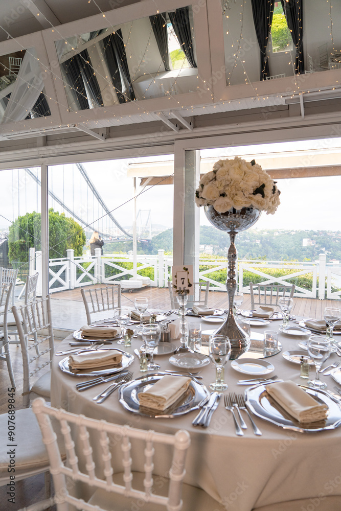 Stylish Outdoor Reception: Lounge Furniture with Floral Accents and Urban Panorama