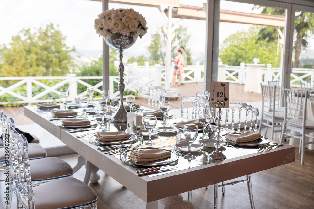 Stylish Outdoor Reception: Lounge Furniture with Floral Accents and Urban Panorama