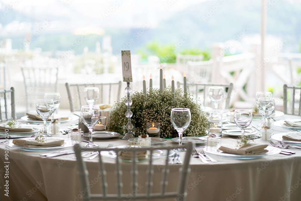 Charming Outdoor Wedding Table Arrangement with White Chairs