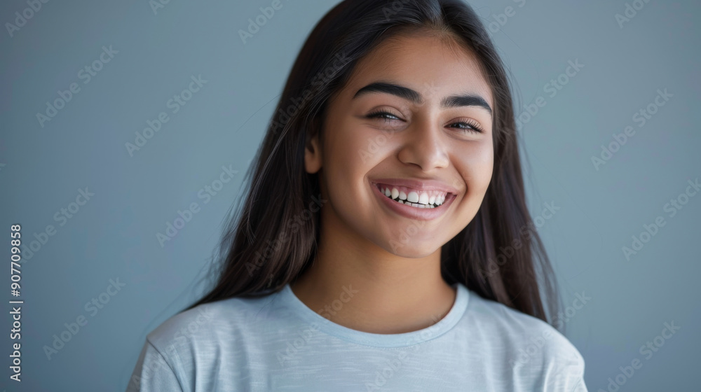 A radiant young woman with a warm smile poses in a modern, plant-filled room, her vibrant yellow top adding a cheerful note to the bright, airy atmosphere. A radiant young woman with a warm smile poses in a modern, plant-filled room, her vibrant yellow top adding a cheerful note to the bright, airy atmosphere.