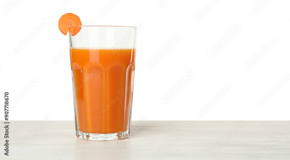 Fresh carrot juice in glass on wooden table against white background. Space for text Fresh carrot juice in glass on wooden table against white background. Space for text