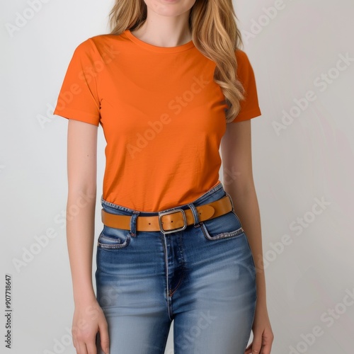  TShirt Mockup Colored TShirt on a Beautiful Woman Wearing Jeans with Arms at Her Sides Against a Plain White Background