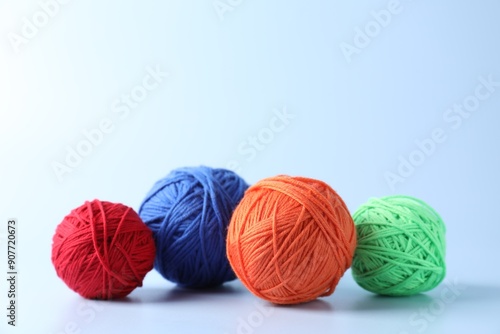 Different colorful yarns on light background. Space for text