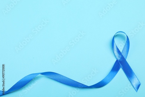 Blue ribbon on color background, top view with space for text. Prostate cancer awareness photo