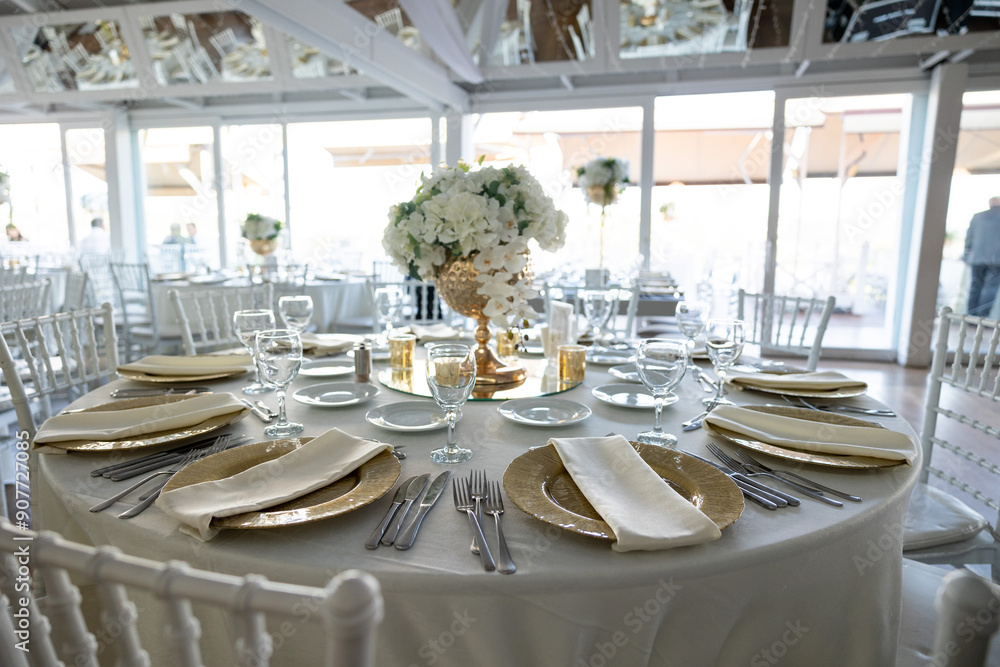 Elegant Wedding Table with White Flowers and Greenery at Outdoor Reception