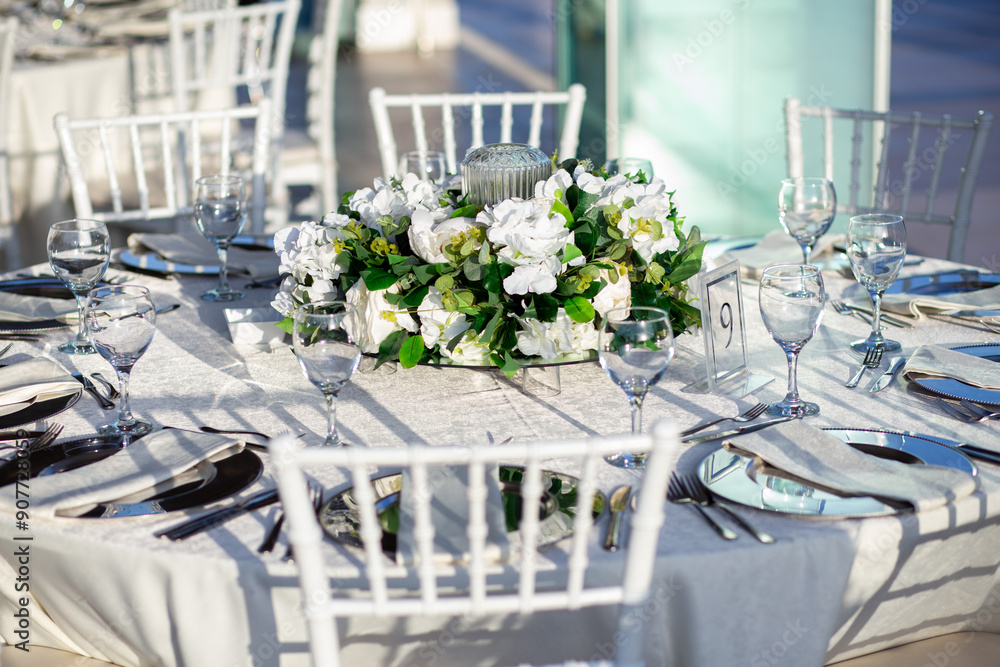 Elegant Wedding Table with White Flowers and Greenery at Outdoor Reception