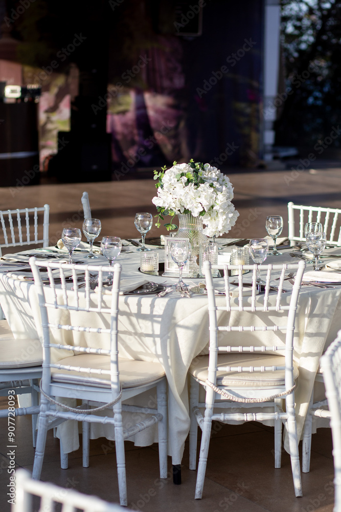 Elegant Wedding Table with White Flowers and Greenery at Outdoor Reception