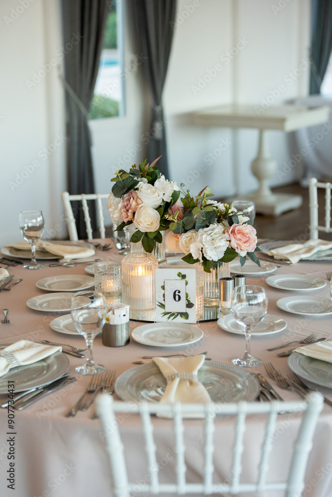 Elegant Wedding Table with Pastel Flowers and Greenery at Indoor Reception